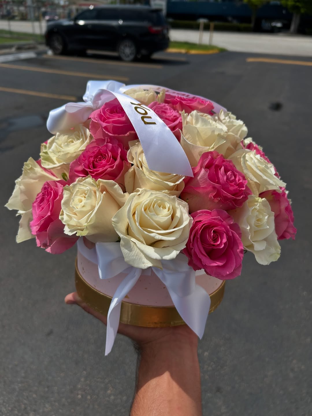 Arrangement of 25 mixed roses in a round box
