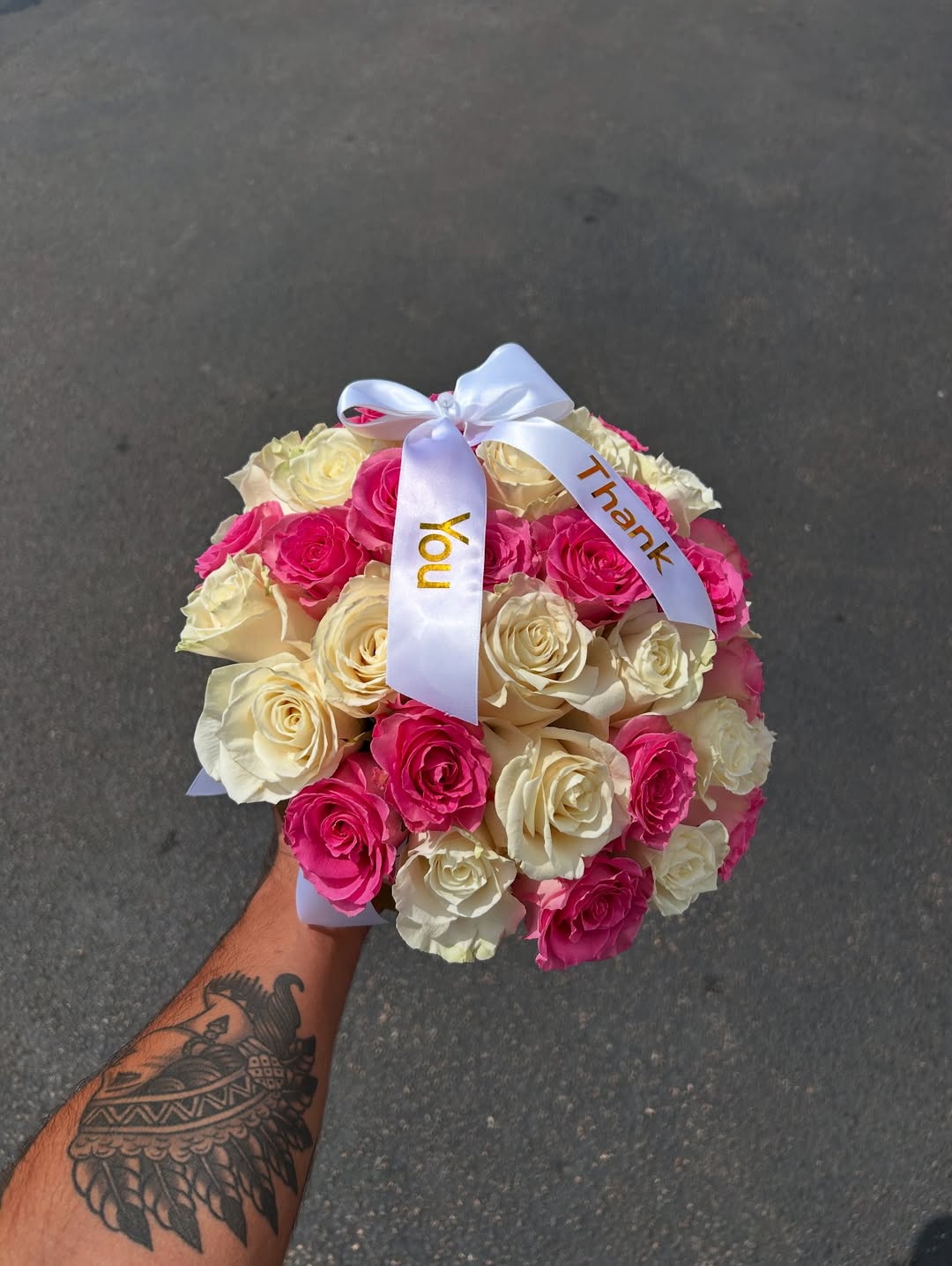 Arrangement of 25 mixed roses in a round box